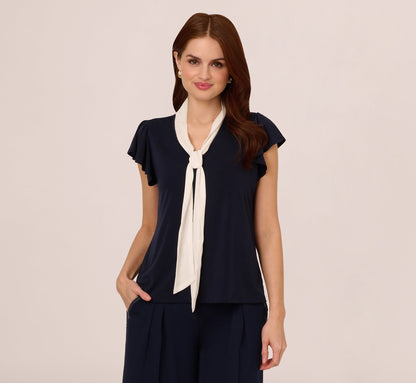 Flutter Sleeve Tie Neck Knit Top In Navy Ivory